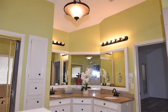 a bathroom with a double vanity sink and a mirror