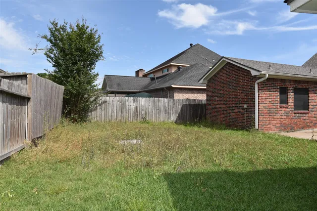 a front view of a house with a yard and outdoor seating