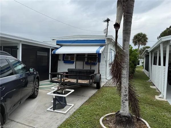 a house view with a garden space and patio