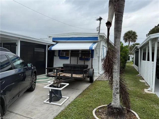 a house view with a garden space and patio