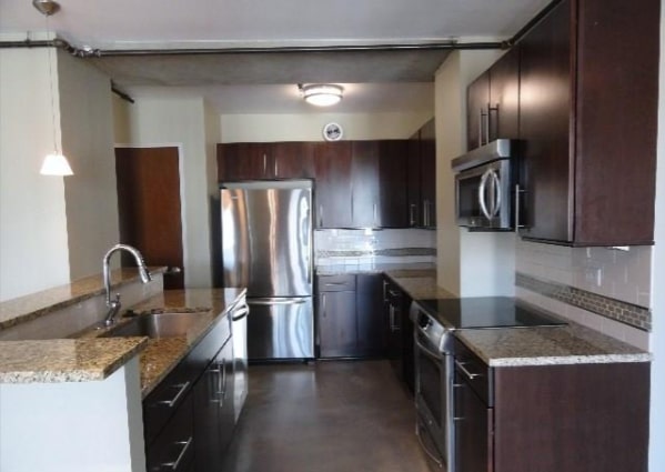 800 Brazos Street, Unit 1006 Austin, TX 78701 - Photo 3 of 26 a kitchen with stainless steel appliances granite countertop a sink stove and refrigerator