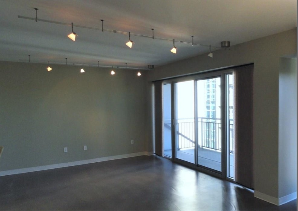 800 Brazos Street, Unit 1006 Austin, TX 78701 - Photo 5 of 26 an empty room with wooden floor and windows