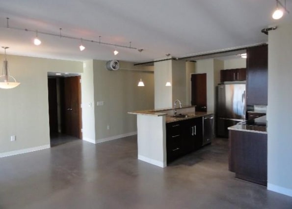 800 Brazos Street, Unit 1006 Austin, TX 78701 - Photo 6 of 26 a large kitchen with a sink and stainless steel appliances