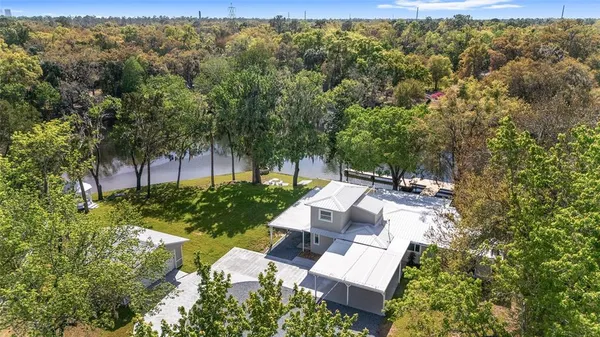 a view of backyard of house with outdoor seating