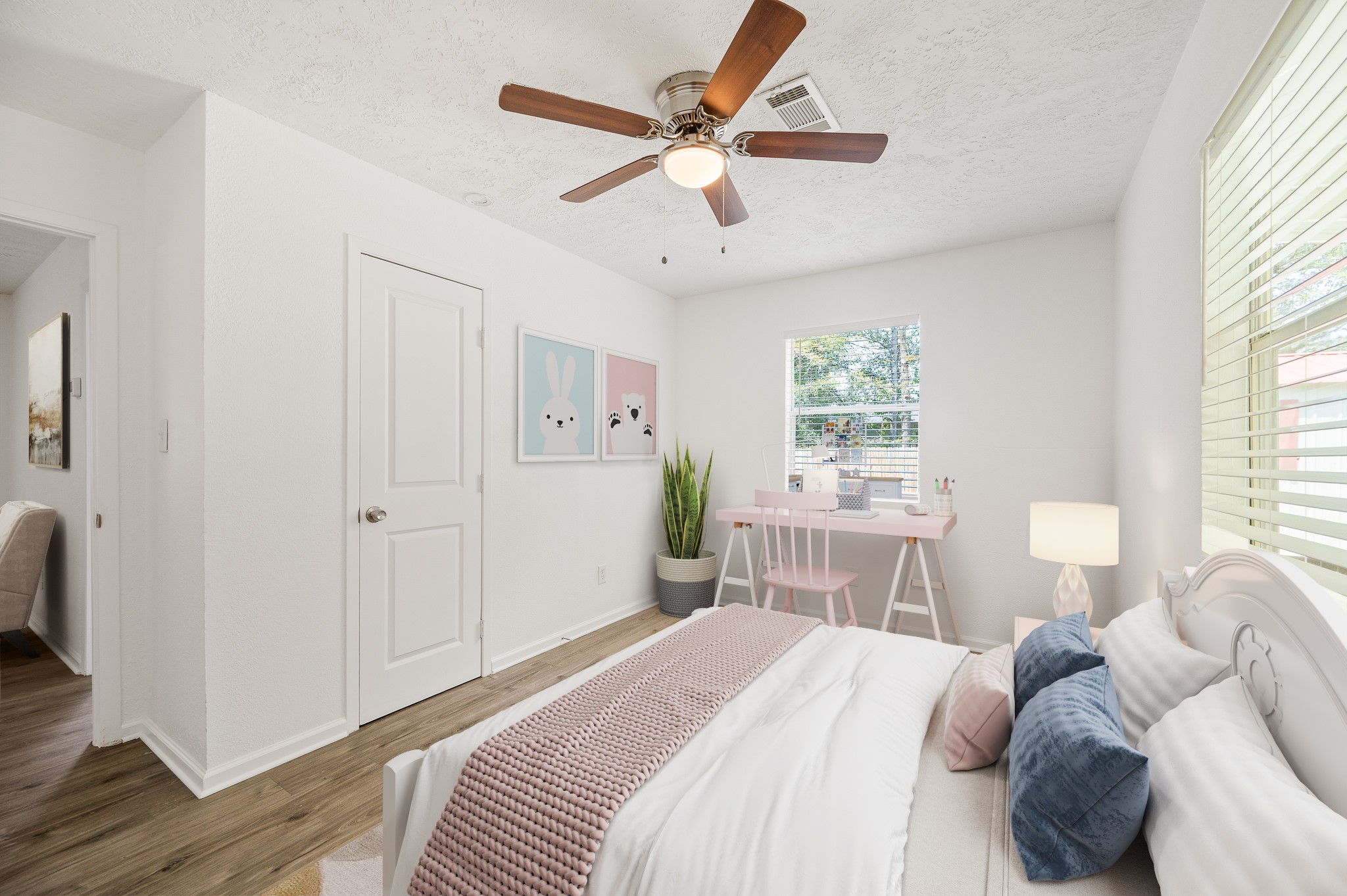61 Hicks Loop West Cleveland, TX 77328 - Photo 21 of 38 Bright and cozy bedroom featuring a ceiling fan, a stylish workspace, and abundant natural light.