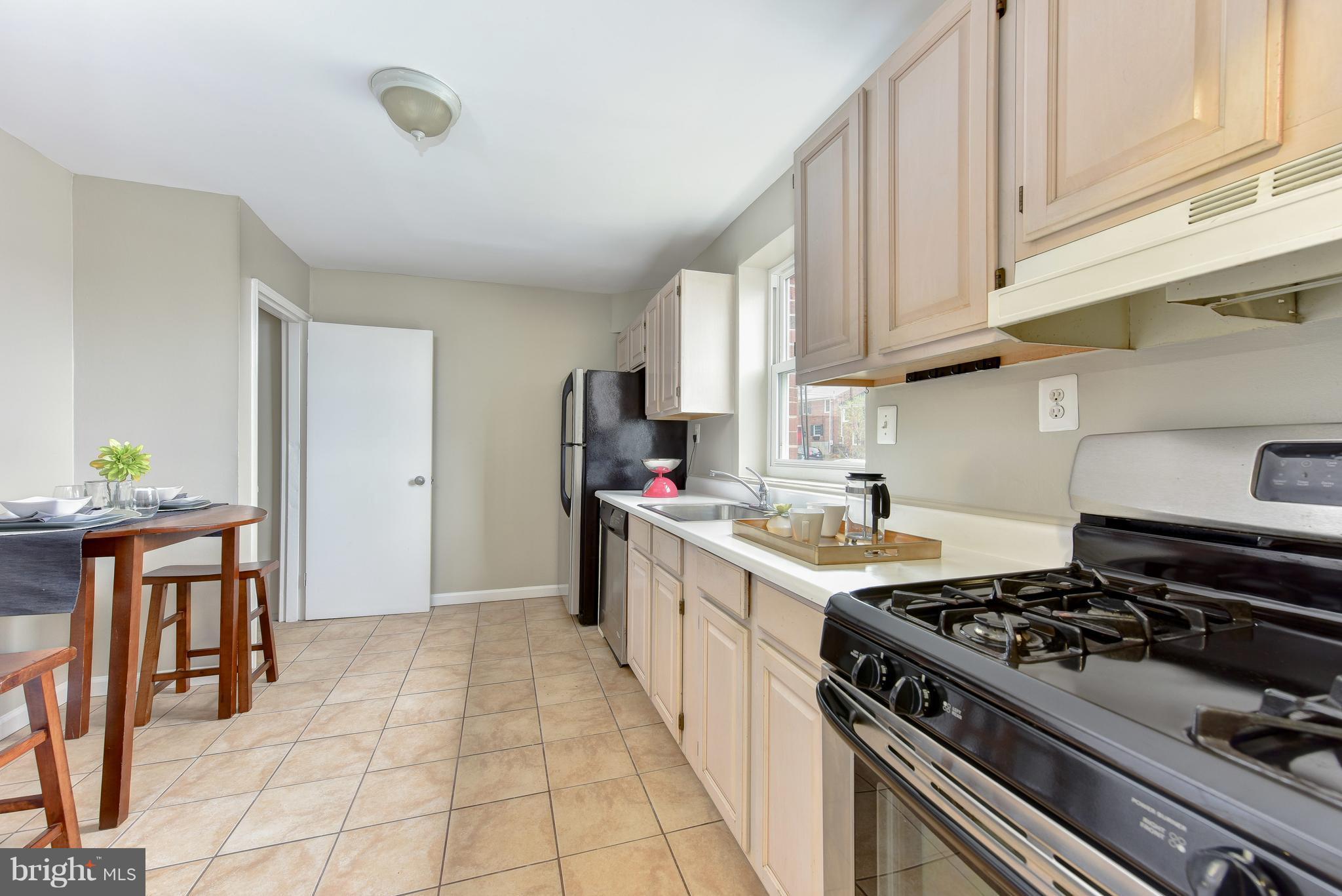 2918 Hickory Street Alexandria, VA 22305 - Photo 11 of 30 a kitchen with stainless steel appliances granite countertop a stove a sink dishwasher and a refrigerator