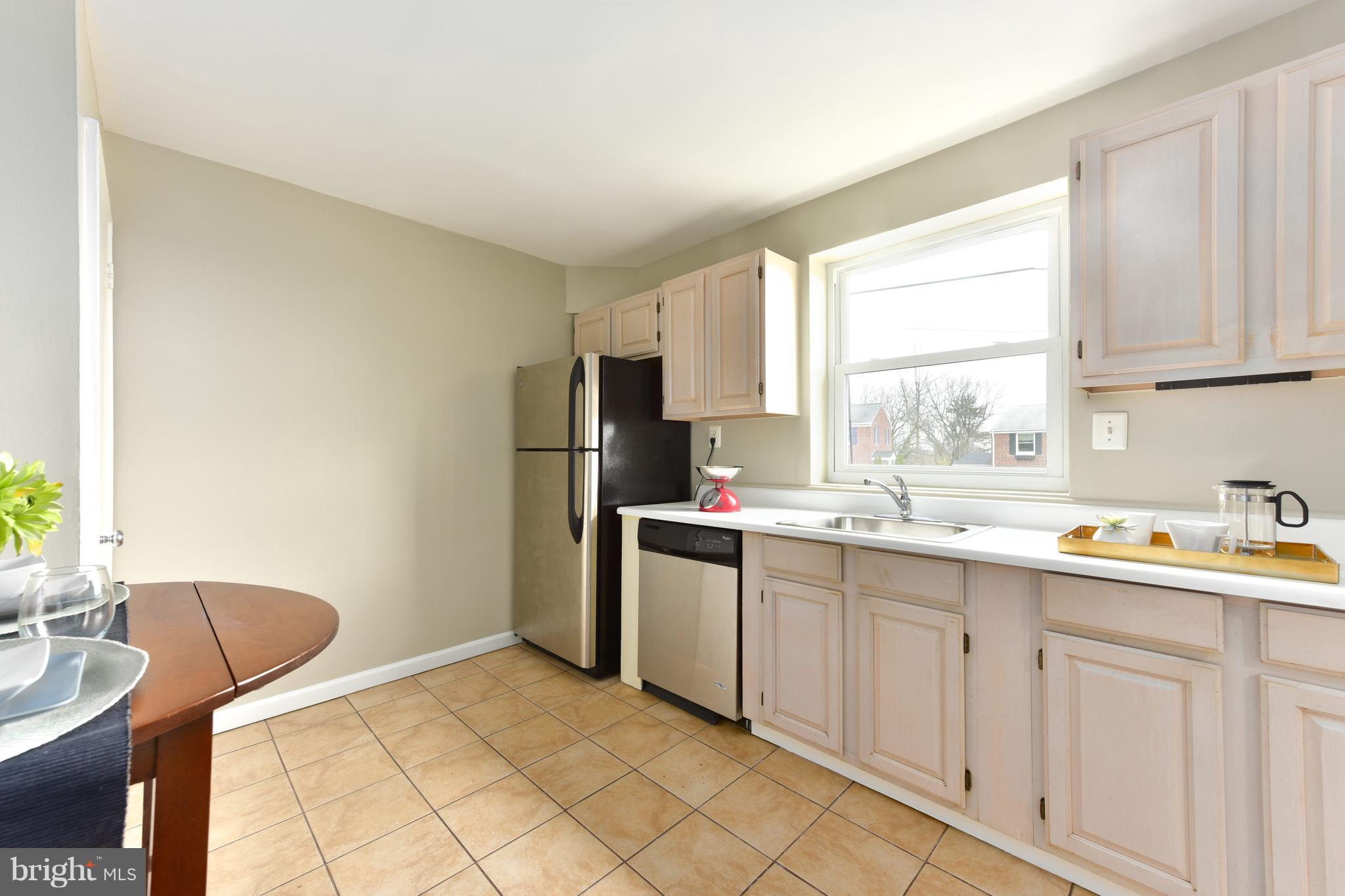 2918 Hickory Street Alexandria, VA 22305 - Photo 12 of 30 a kitchen with stainless steel appliances a refrigerator sink and cabinets