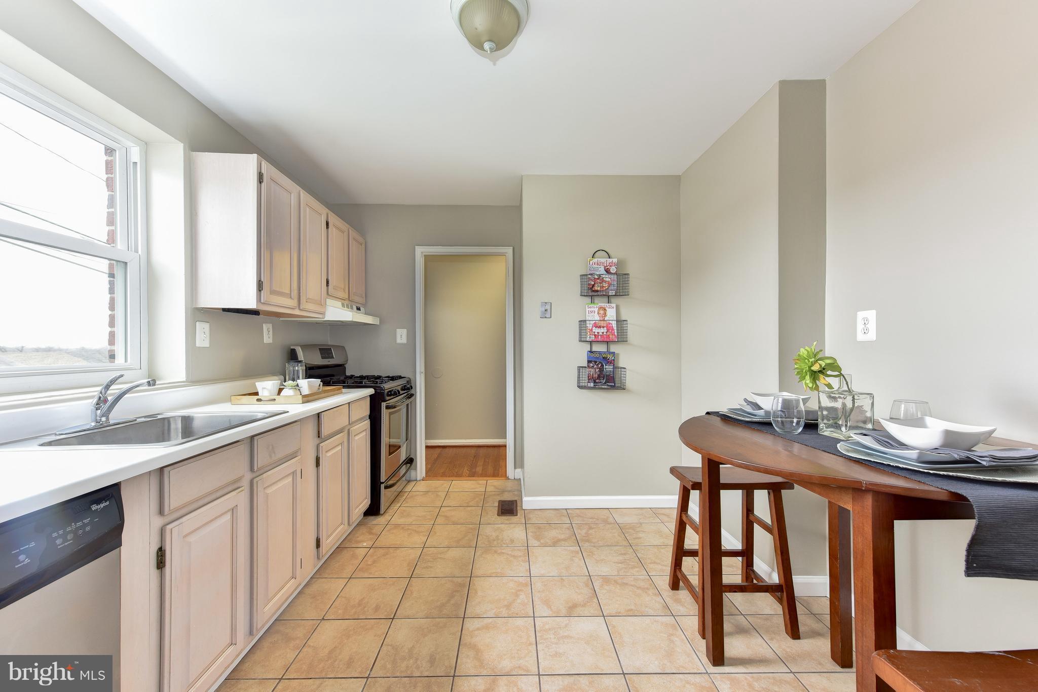 2918 Hickory Street Alexandria, VA 22305 - Photo 13 of 30 a kitchen with stainless steel appliances granite countertop a sink and cabinets
