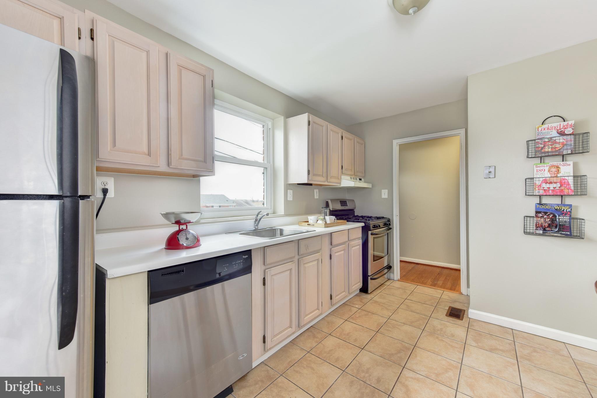 2918 Hickory Street Alexandria, VA 22305 - Photo 14 of 30 a kitchen with a sink cabinets and window