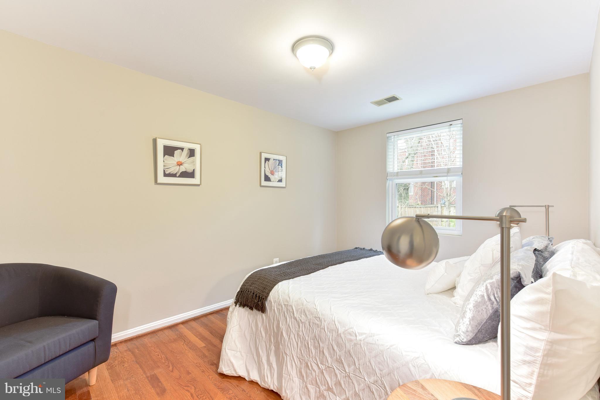 2918 Hickory Street Alexandria, VA 22305 - Photo 18 of 30 a bedroom with a bed and wooden floor