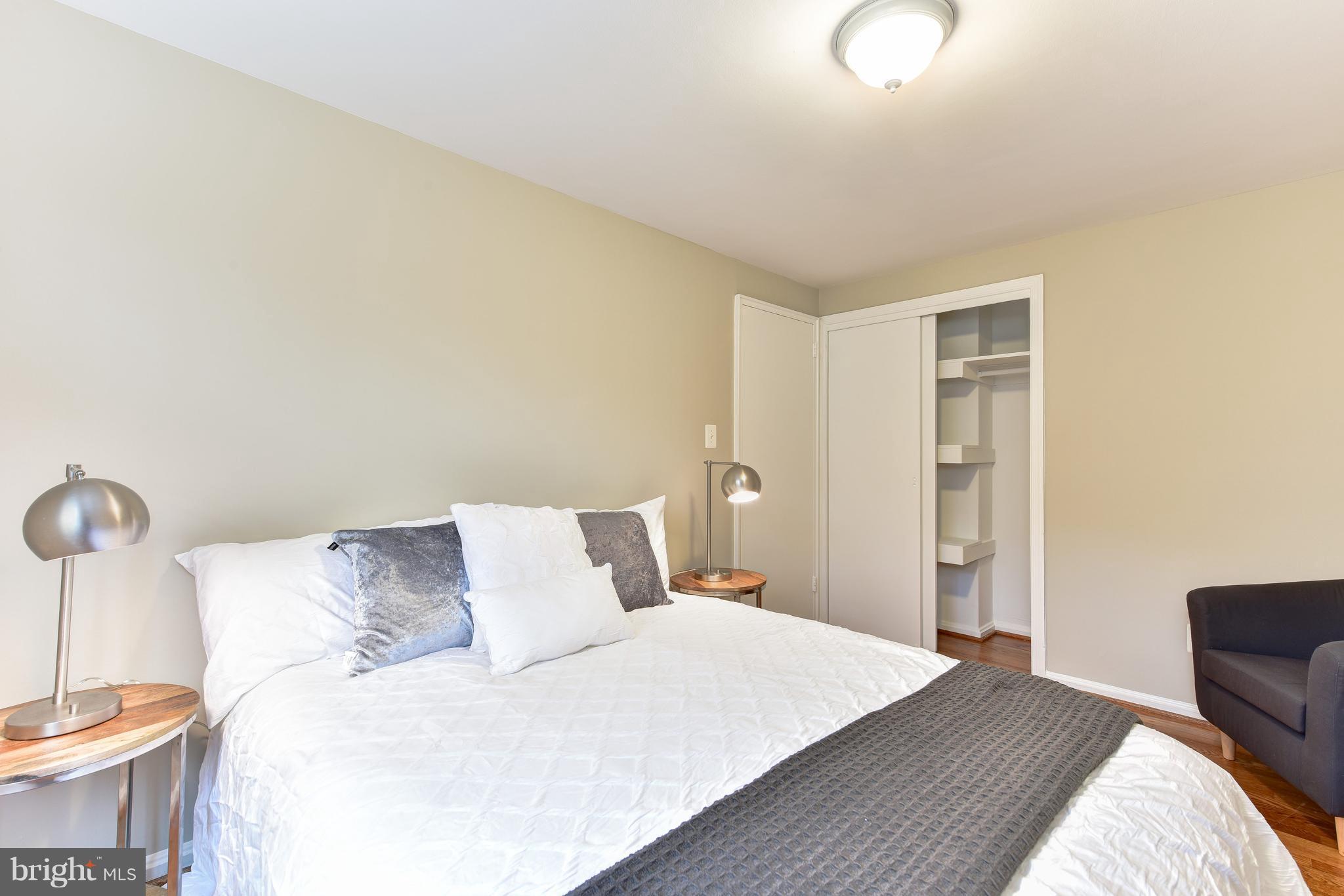 2918 Hickory Street Alexandria, VA 22305 - Photo 19 of 30 a bedroom with a bed and a chair