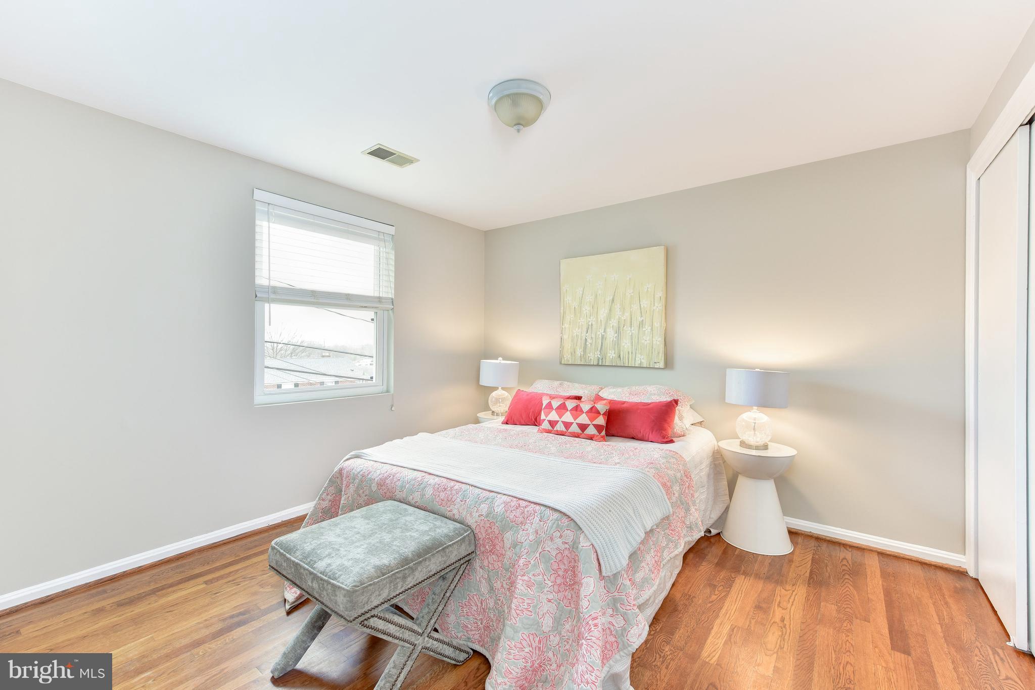2918 Hickory Street Alexandria, VA 22305 - Photo 20 of 30 a bedroom with a bed and wooden floor