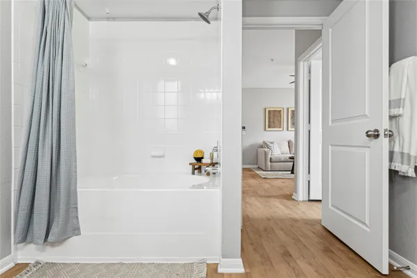 a bathroom with a tub shower and a sink