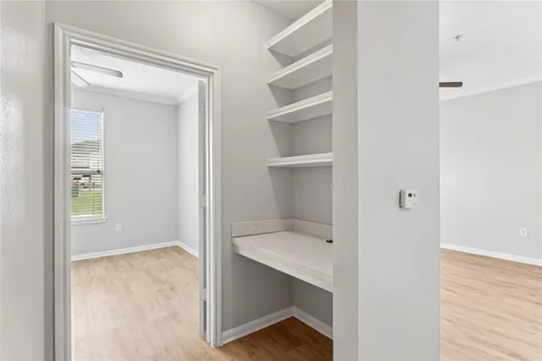 a view of walk in closet with empty racks