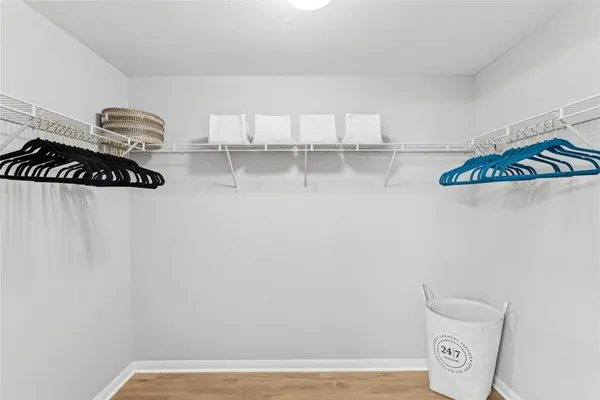 a view of a closet with cabinets