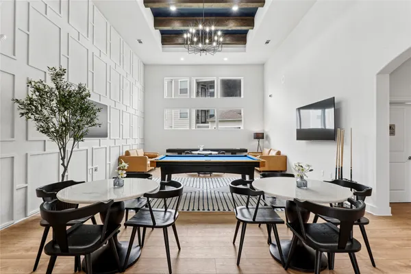 a dining room with furniture and chandelier