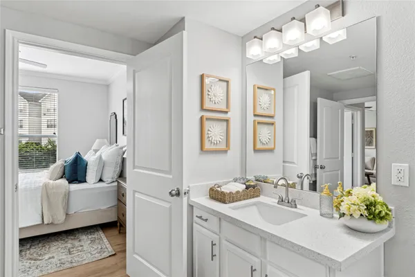 a bathroom with a tub sink and mirror