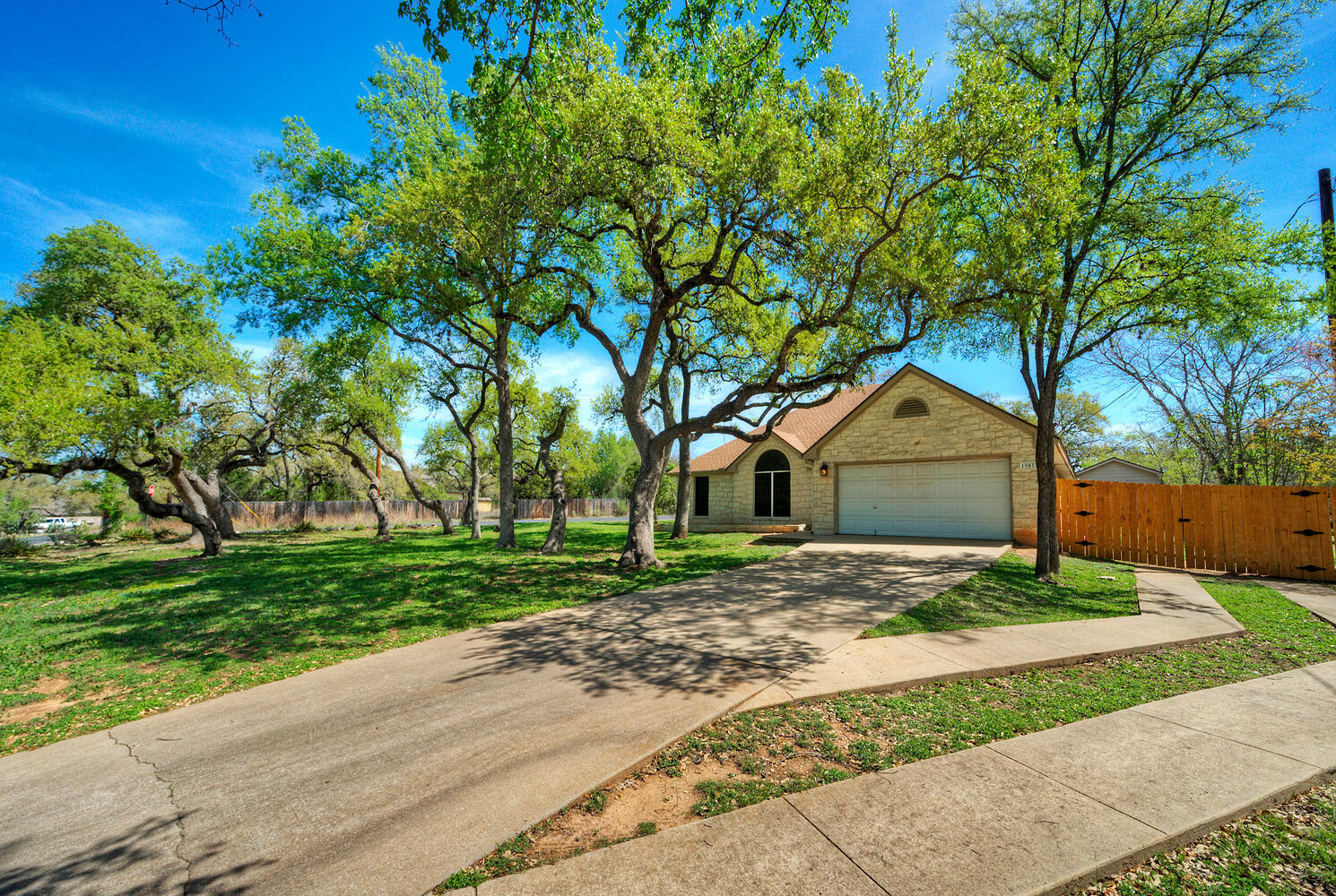 1907 Red Fox Road Austin, TX 78734 - Photo 1 of 1 Ranch-style home with driveway, a gate, and an attached garage