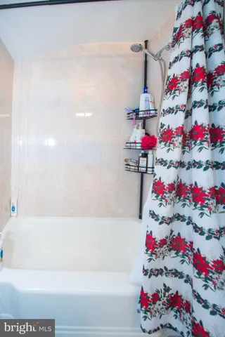 a bathroom with a bathtub and shower