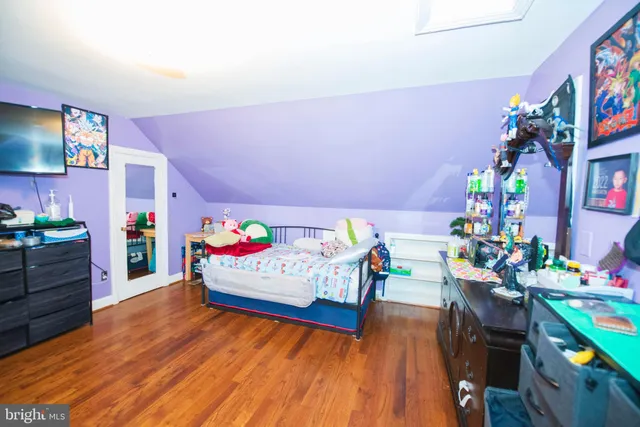 a bedroom with furniture and a wooden floor