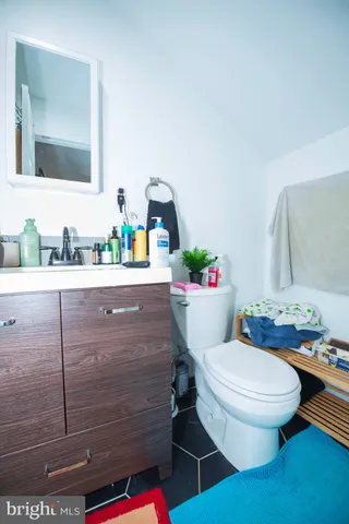 a bathroom with a sink mirror vanity and toilet