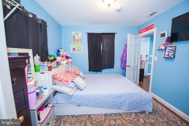 a bedroom with a bed and a dresser