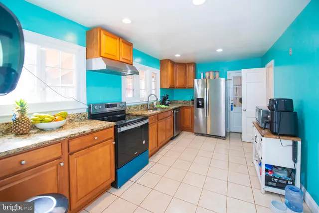 a kitchen with stainless steel appliances a sink and a refrigerator