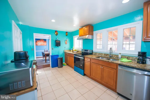 a kitchen with stainless steel appliances a sink counter space and a window