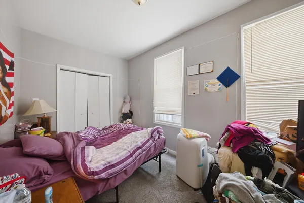 a bedroom with a bed and a chandelier