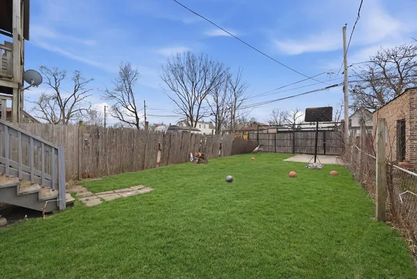 a view of a backyard with a fence