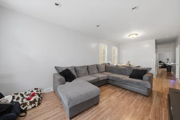 a living room with furniture and flowers