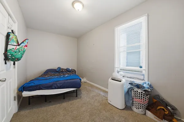 a room with a rug toys and a window