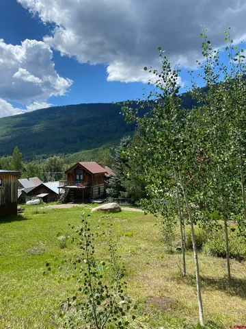 a view of a garden with a building in the background