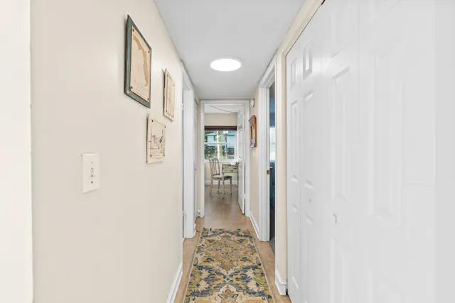 a bedroom with a bed a dresser and next to a window