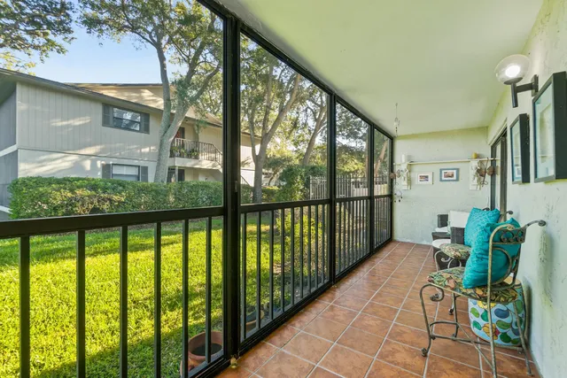 a balcony with table and chairs