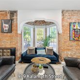 a living room with furniture a rug and a large window