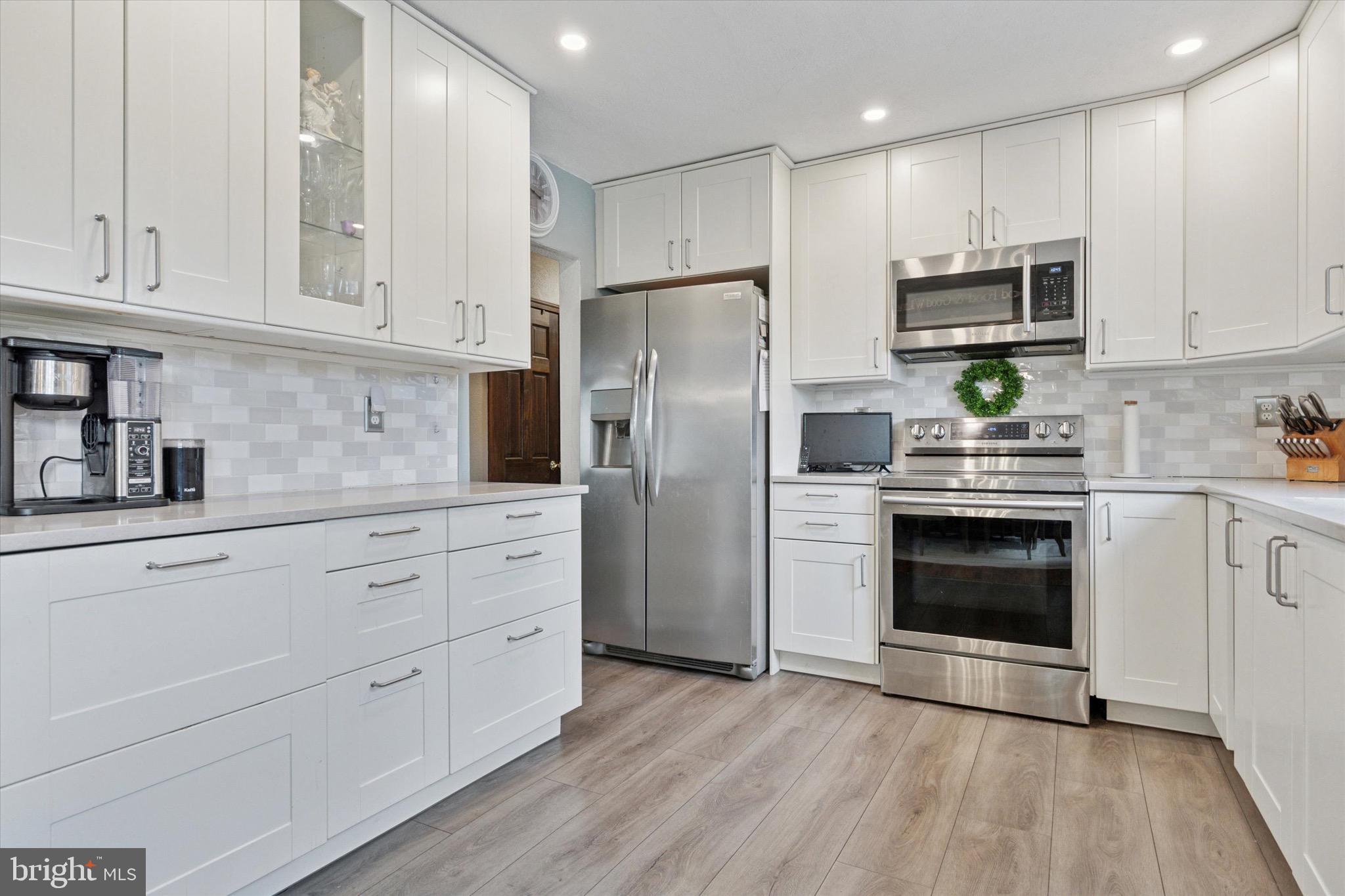 217 Hoffecker Road Phoenixville, PA 19460 - Photo 8 of 25 a kitchen with stainless steel appliances white cabinets and a refrigerator