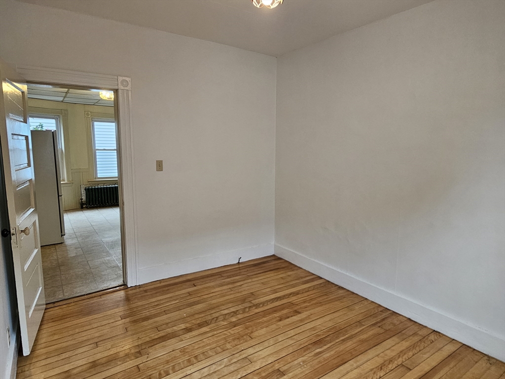 20 Kosta Street, Unit 1 Worcester, MA 01607 - Photo 11 of 17 a view of empty room with wooden floor