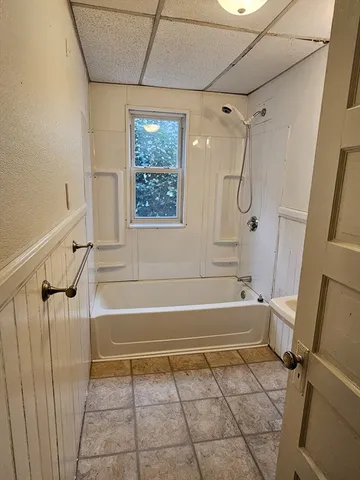 a bathroom with a bathtub and a shower