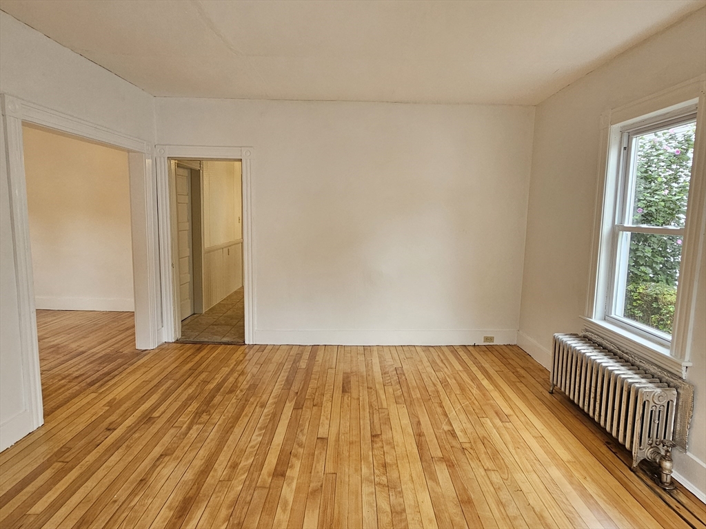 20 Kosta Street, Unit 1 Worcester, MA 01607 - Photo 3 of 17 a view of a room with wooden floor and brick walls