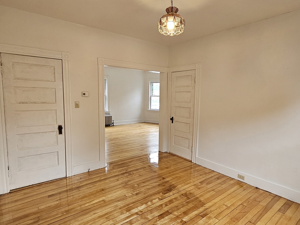 20 Kosta Street, Unit 1 Worcester, MA 01607 - Photo 5 of 17 wooden floor in an empty room with a window