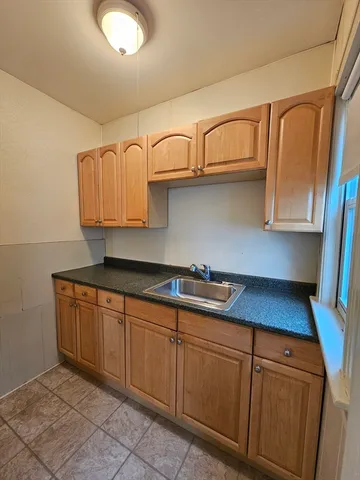 a kitchen with stainless steel appliances granite countertop a sink and cabinets