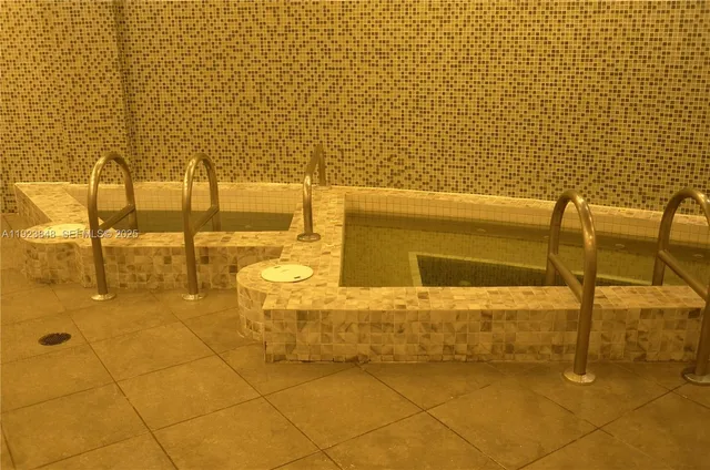 a living room with couches and a dining table with wooden floor