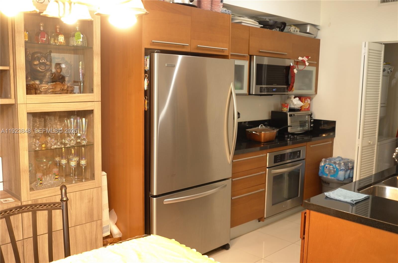 253 Northeast 2nd Street, Unit 908 Miami, FL 33132 - Photo 34 of 47 a kitchen with stainless steel appliances a refrigerator stove and microwave