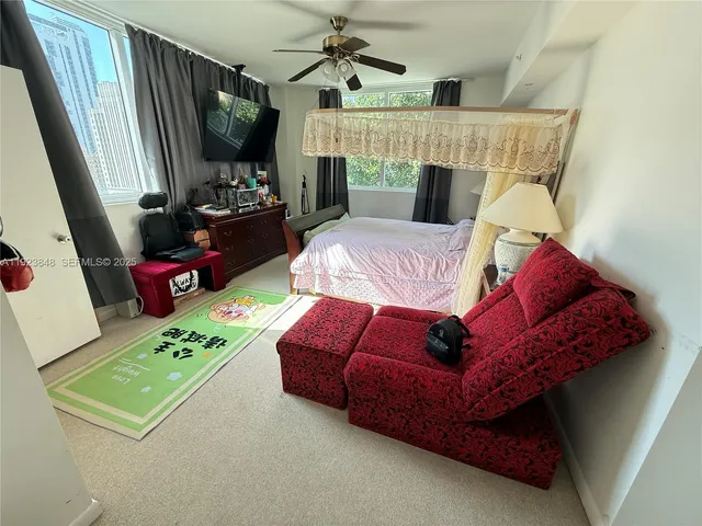 a living room with furniture fireplace and flat screen tv