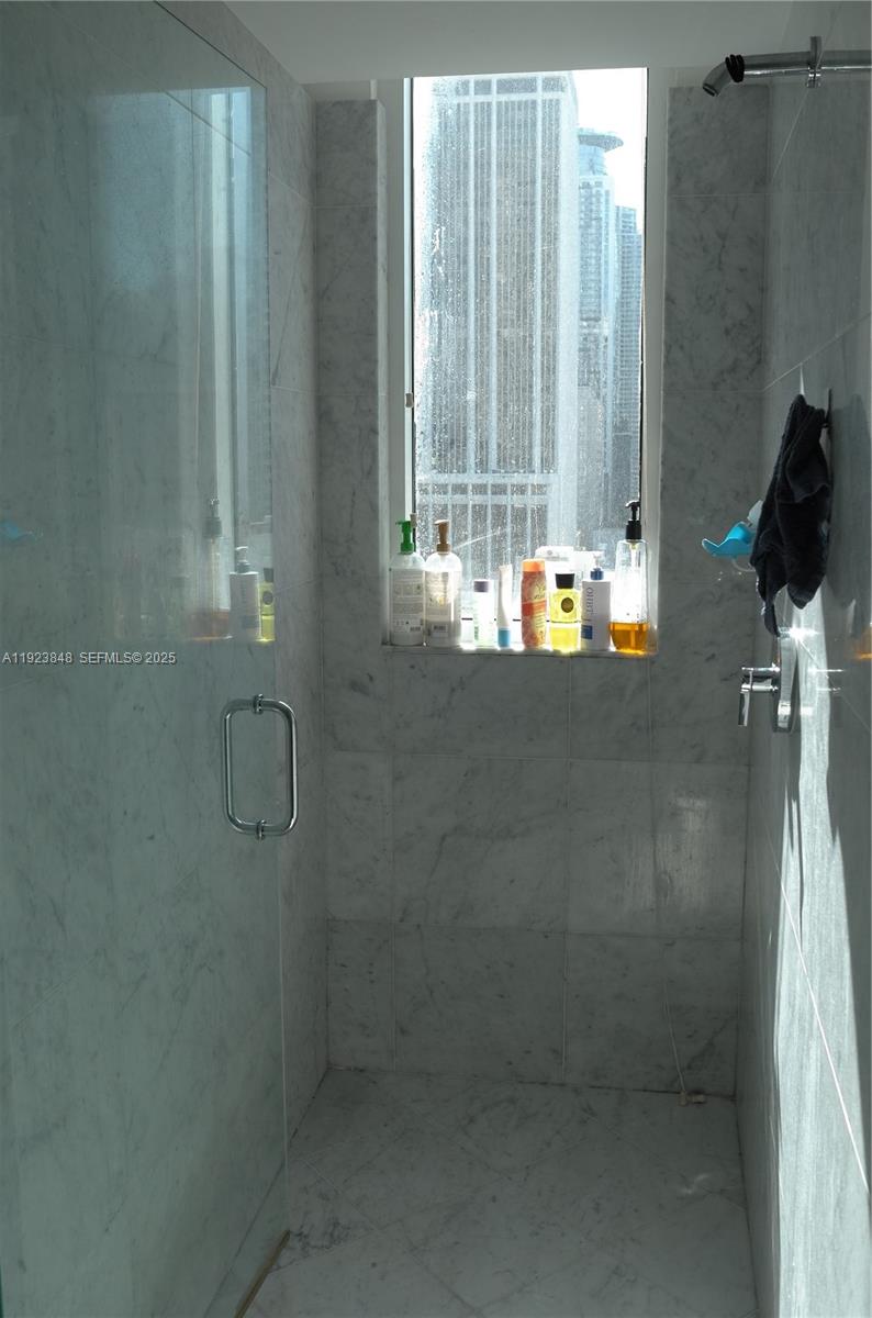 253 Northeast 2nd Street, Unit 908 Miami, FL 33132 - Photo 45 of 47 a bathroom with a shower