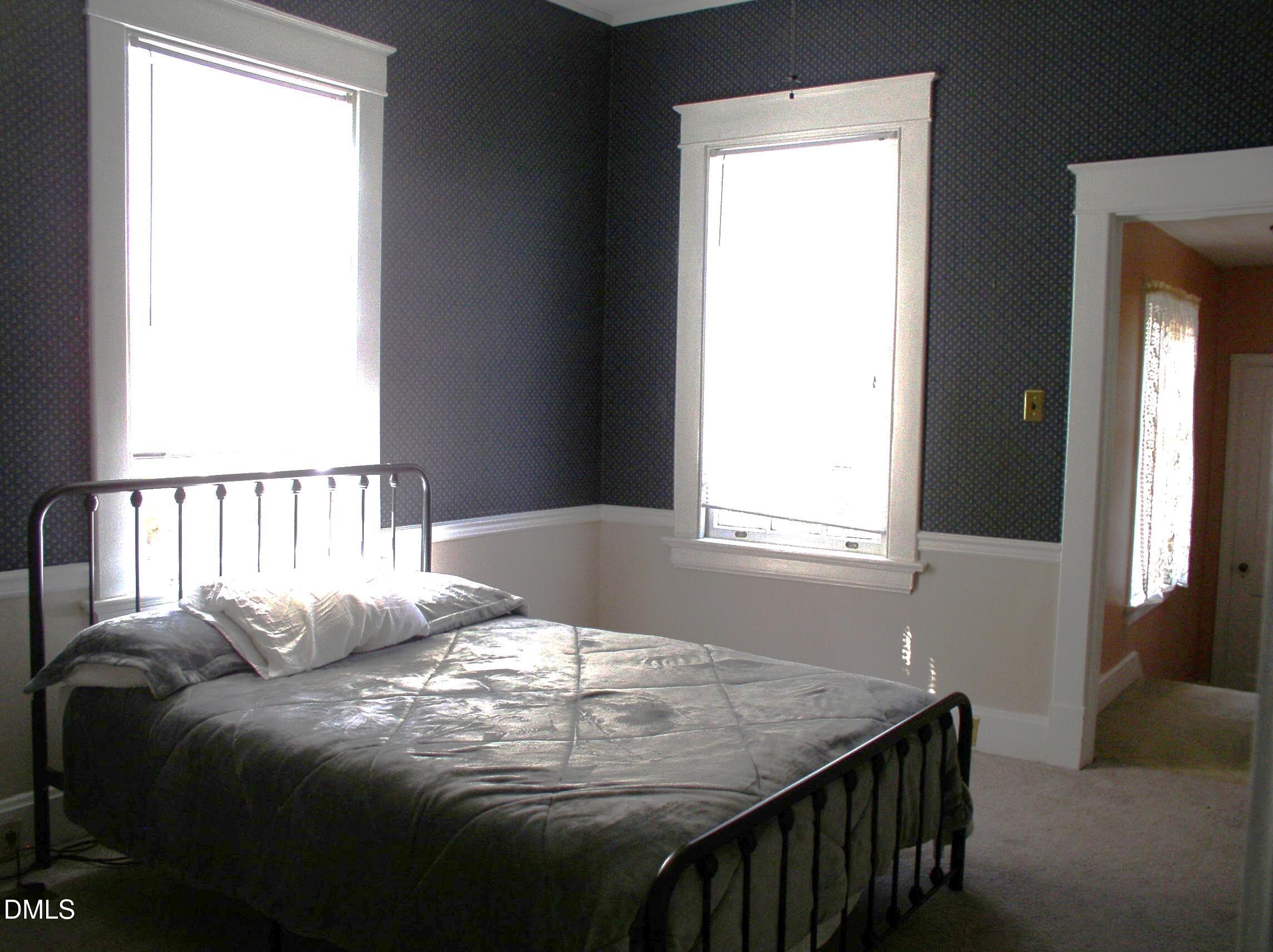 934 South Chestnut Street Henderson, NC 27536 - Photo 15 of 56 a bedroom with a bed and a window