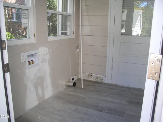 a view of a bench in back yard of a house