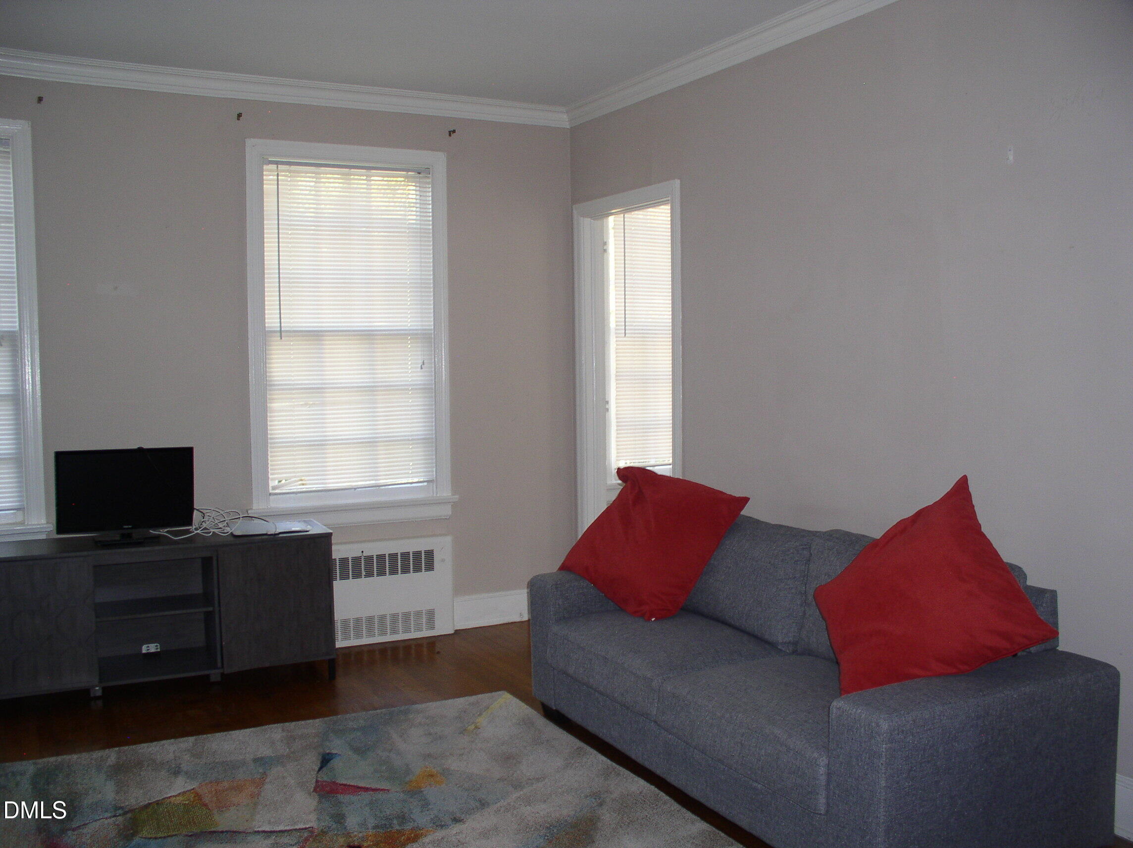 934 South Chestnut Street Henderson, NC 27536 - Photo 38 of 56 a living room with furniture and a flat screen tv