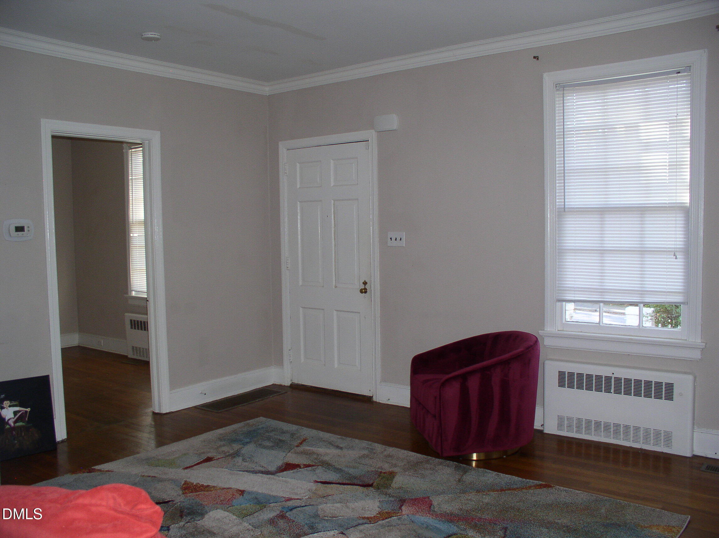 934 South Chestnut Street Henderson, NC 27536 - Photo 39 of 56 a view of an empty room with wooden floor and a window